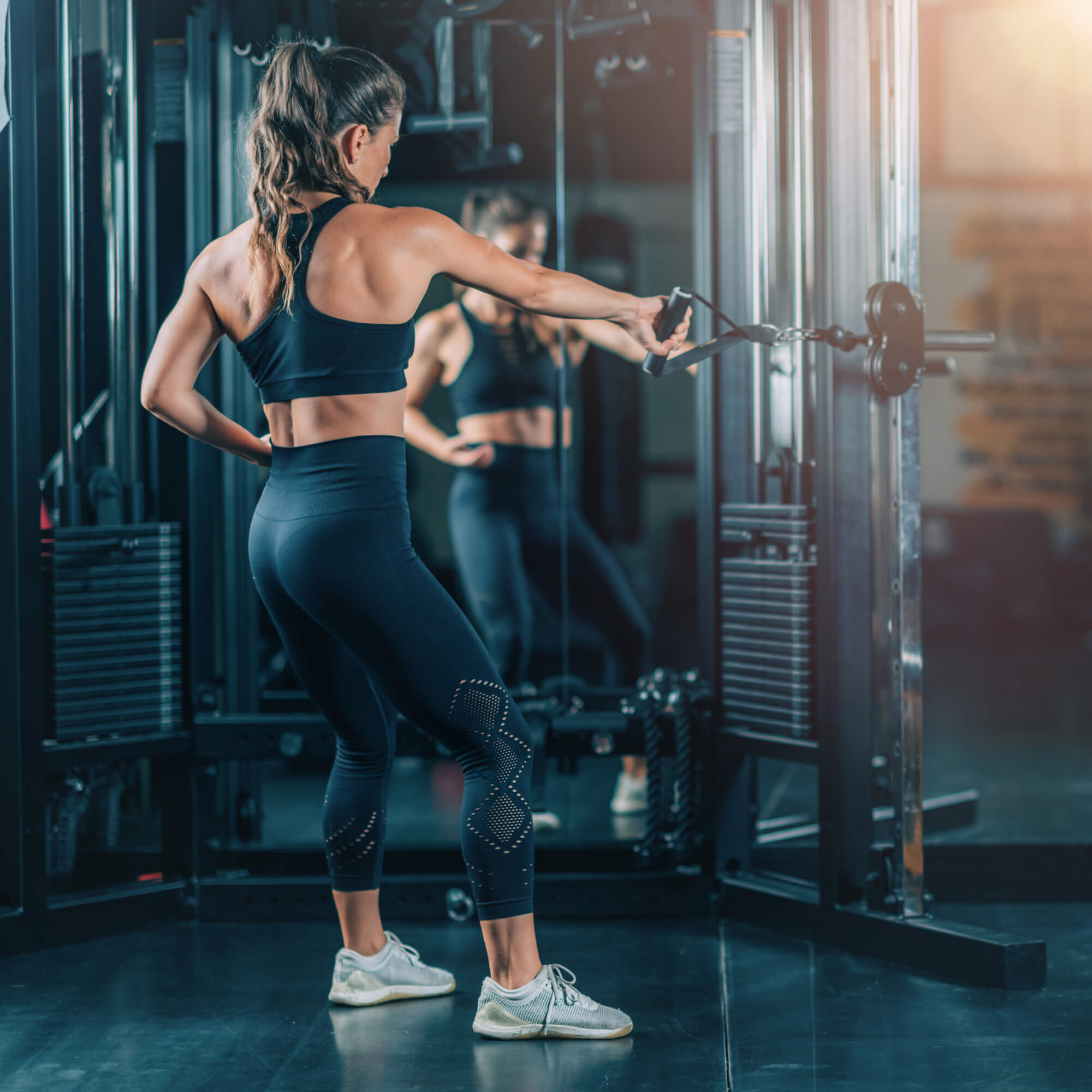 woman-doing-exercise-on-a-machine-in-a-gym-2023-11-27-05-18-40-utc